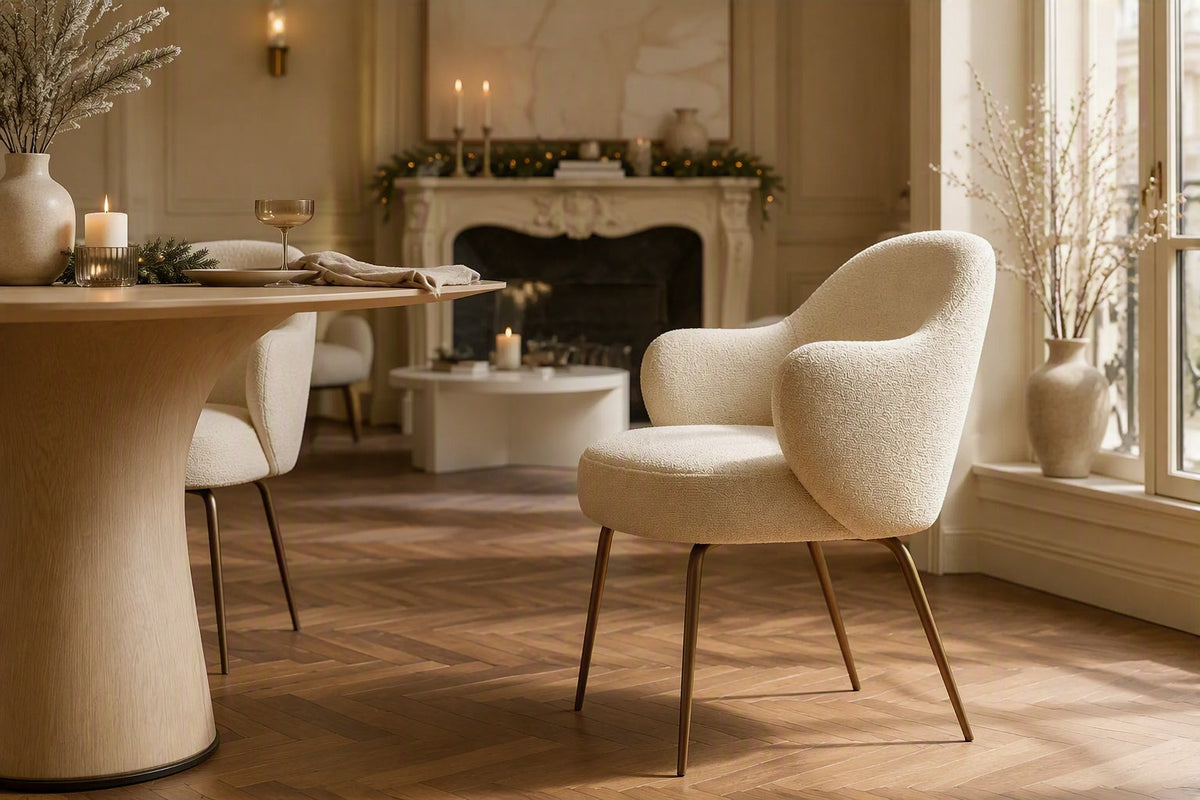 A cream boucle dining chair in a glamorous home with light oak dining table and Christmas decorations
